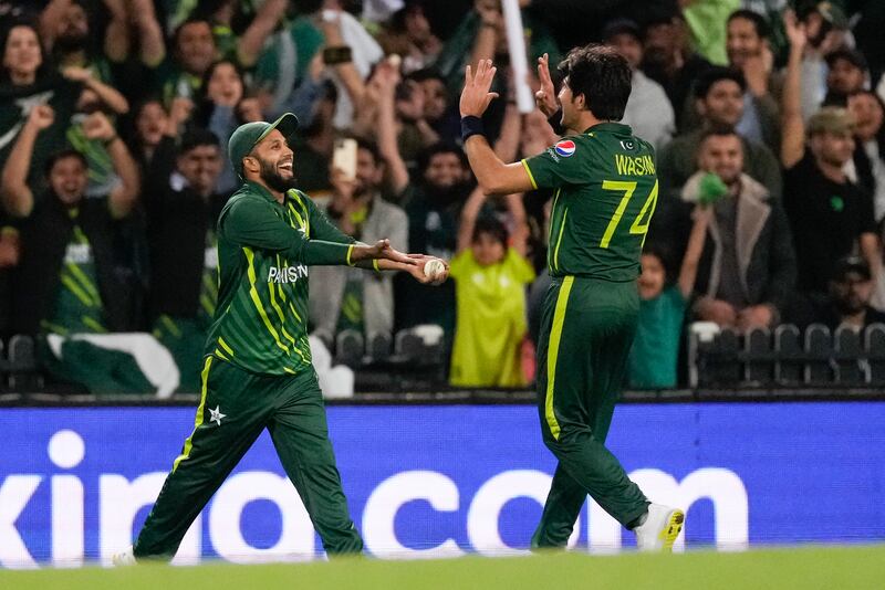 Pakistan's Mohammad Haris, left, is congratulated by teammate Mohammad Wasim after taking a catch to dismiss South Africa's Anrich Nortje. AP