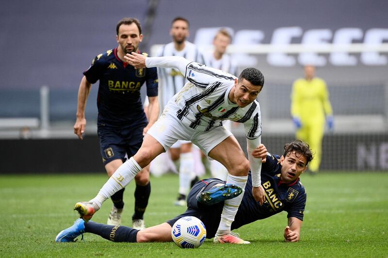 Juventus' Cristiano Ronaldo under pressure from Ivan Radovanovic of Genoa. AP