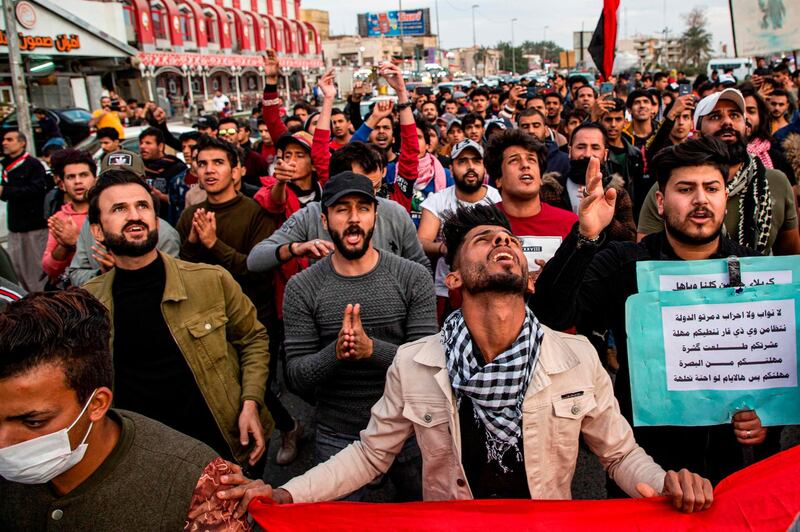 Protesters chant slogans as they march during an anti-government demonstration, also calling for freedom of the press, in the southern Iraqi city of Basra.  AFP