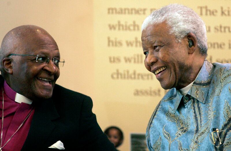 FILE - Former South African President Nelson Mandela, right, reacts with Archbishop Desmond Tutu during the launch of a Walter and Albertina Sisulu exhibition, called, 'Parenting a Nation', at the Nelson Mandela Foundation in Johannesburg, South Africa, Wednesday, March 12, 2008.  Tutu, South Africa's Nobel Peace Prize-winning activist for racial justice and LGBT rights and the retired Anglican Archbishop of Cape Town, has died at the age of 90, it was announced on Sunday, Dec.  26, 2021.  An uncompromising foe of apartheid, South Africa's brutal regime of oppression again the Black majority, Tutu worked tirelessly, but non-violently, for its downfall. (AP Photo / Themba Hadebe, File)