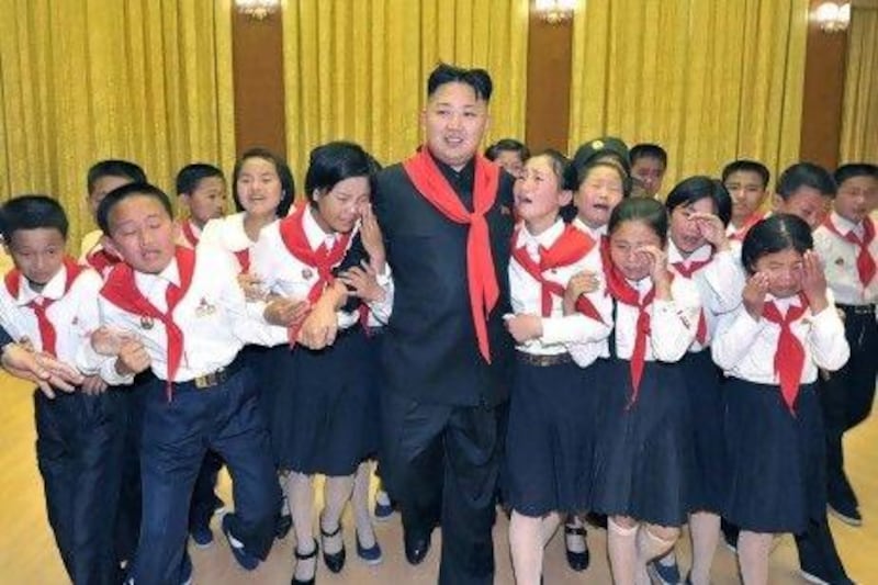 Kim Jong-un, the North Korean leader, walks surrounded by 'weeping' members of the Korean Children's Union (KCU).