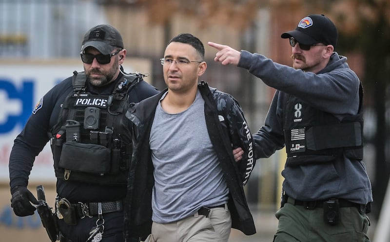 Solomon Pena is taken into custody by Albuquerque Police officers. AP