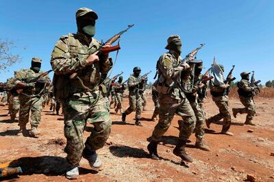 Syrian fighters attend a mock battle in anticipation of an attack by the regime on Idlib province and the surrounding countryside, during a graduation of new Hayat Tahrir al-Sham (HTS) members at a camp in the countryside of the northern Idlib province on August 14, 2018. (Photo by OMAR HAJ KADOUR / AFP)