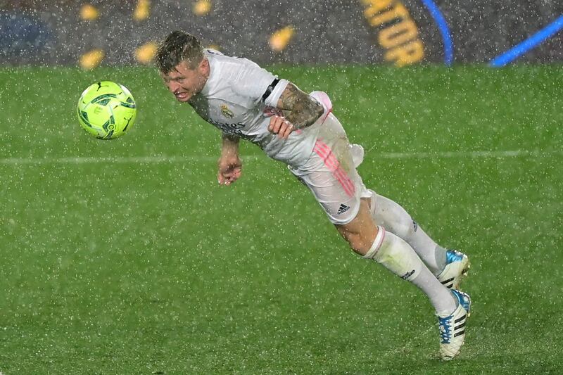 Real Madrid' midfielder Toni Kroos dives for the ball. AFP