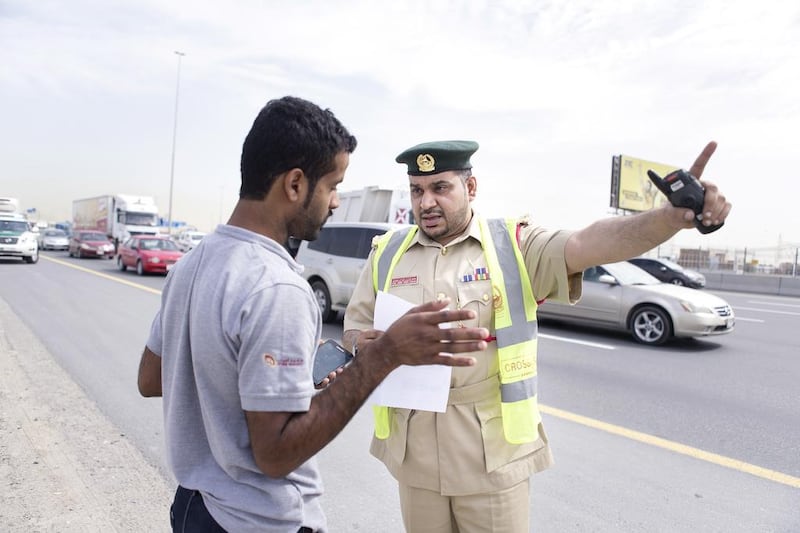 First Lieutenant, Essa Ahmed helps a man, who stopped to ask for directions. Reem Mohammed / The National