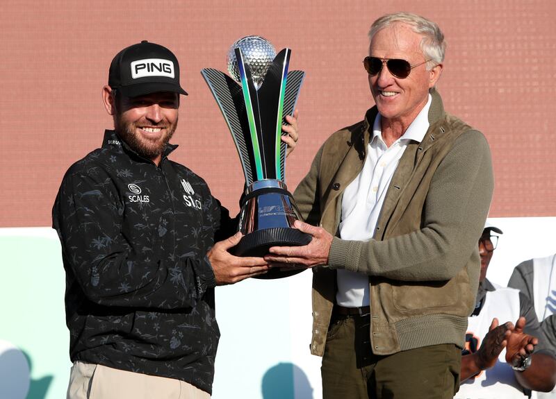 South Africa's Louis Oosthuizen receives the LIV Golf Invitational Team trophy from LIV Golf CEO Greg Norman. PA