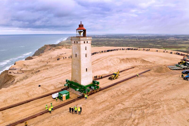 Aerial view shows people looking on as the lighthouse in Rubjerg Knude is being moved away from the coastline between Lonstrup and Lokken, Jutland, Denmark. AFP