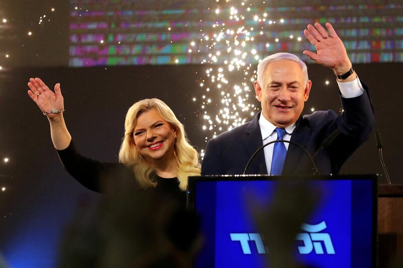 FILE PHOTO: Israeli Prime Minister Benjamin Netanyahu and his wife Sara wave as Netanyahu speaks following the announcement of exit polls in Israel's parliamentary election at the party headquarters in Tel Aviv, Israel April 10, 2019. REUTERS/Ammar Awad/File Photo