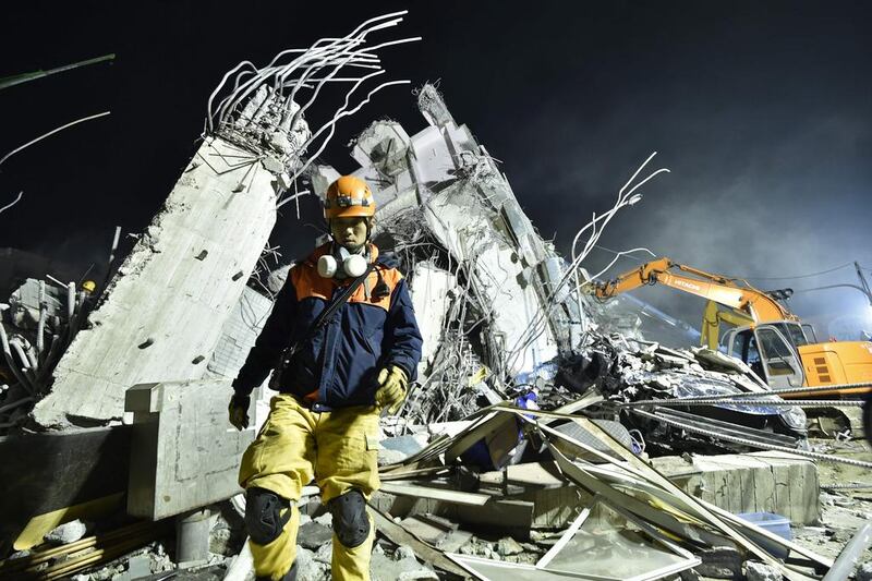 Rescue personnel work at the site of a collapsed building in the southern Taiwanese city of Tainan on Saturday following a strong 6.4-magnitude earthquake.  Sam Yeh / AFP