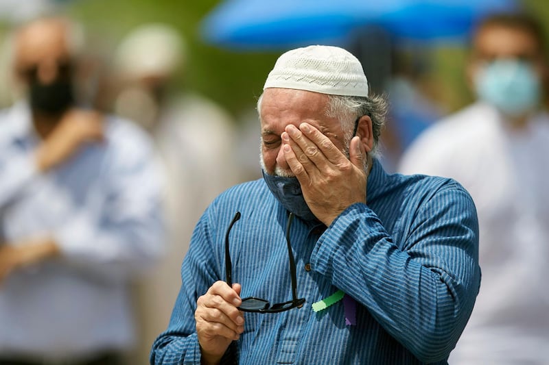 A man wipes away a tear during the funeral service for the victims of the deadly vehicle attack on five members of the Canadian Muslim community in London, Ontario, Saturday, June 12, 2021. Four members of the family died and one is in critical but stable condition. A 20-year-old male is in custody and has been charged in what police say is a motivated hate crime.  (Geoff Robins/The Canadian Press via AP)
