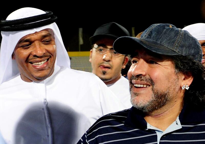 Football legend Diego Maradona (R) visits the Al-Wasl football club of the United Arab Emirates, on May 14, 2011 in Dubai. Al-Wasl club announced on May 16, 2011 that 50-year-old Maradona is to take over as coach next season. AFP PHOTO/STR (Photo by STR / AFP)