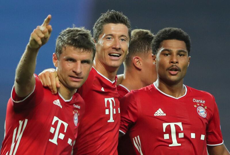 Serge Gnabry, right, celebrates his side's second goal with teammates Robert Lewandowski, centre, and Thomas Mueller. AP