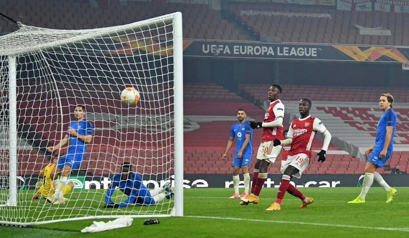 Arsenal's Eddie Nketiah, right, and Nicolas Pepe watch as the ball goes into the net. AFP