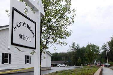 FILE PHOTO: The sign for the new Sandy Hook Elementary School at the end of the drive leading to the school is pictured in Newtown, Connecticut, U.S. July 29, 2016. The officials unveiled the newly constructed school, built to replace the building torn down after a gunman shot dead 20 young children and six educators in a 2012 massacre. REUTERS/Michelle McLoughlin//File Photo