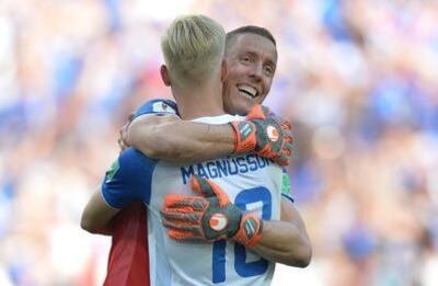 Iceland goalkeeper Hannes Halldorsson of Iceland embraces teammate Hordur Magnusson. Peter Powell / EPA