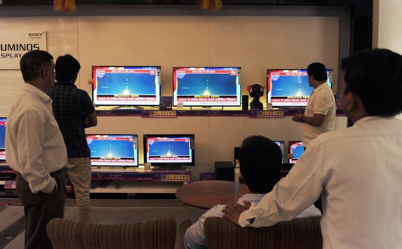 People watch the live telecast of the blast-off of India’s first mission to Mars yesterday. A reader says India’s scientific gains could be reversed if it fails to tackle social inequality. Sajjad Hussein / AFP



