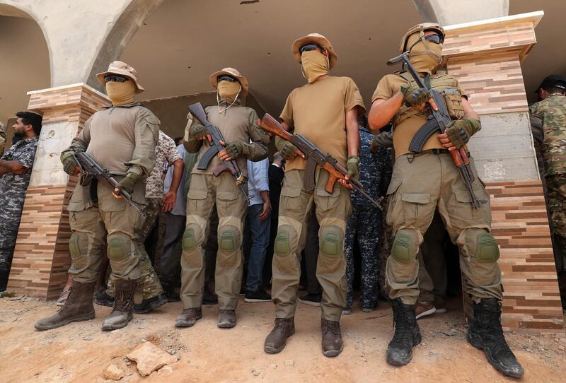 Fighters from the Libyan Government of National Accord (GNA) stand guard on June 20, 2021, in the town of Buwairat Al Hassoun. AFP