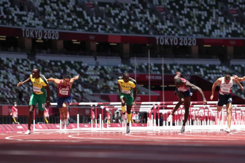 Gold medalist Hansle Parchment of Team Jamaica, bronze medalist Ronald Levy of Team Jamaica and silver medalist Grant Holloway of Team United States compete in the Men's 110m Hurdles Final.