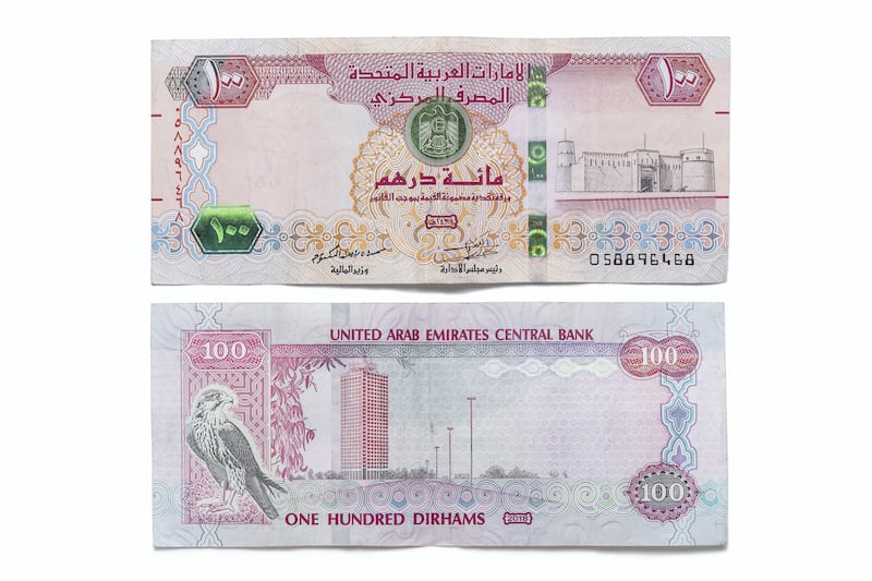 DUBAI, UNITED ARAB EMIRATES. 12 APRIL 2021. United Arab Emirates currency, UAE Money. One hundred dirham bank note, 100 aed. (Photo: Antonie Robertson/The National) Journalist: Juman Jarallah. Section: National.