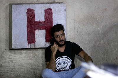 An Iraqi man talks on the phone outside a hospital in the southern city of Basra after the accident on April 2. AFP