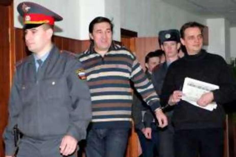 Russian Lieutenant-General, former head of the Federal Drug Control Agency, Alexander Bulbov (C), is escorted into the Moscow City Court on November 12, 2008. Bulbov is accused of illegal wire-tapping of telephones conversations as well as giving and receiving bribes.
                AFP PHOTO / SERGEY SHAKHIDJANIAN *** Local Caption ***  688401-01-08.jpg