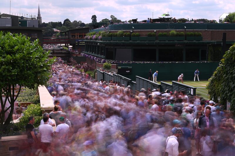 Fans stream past court 18 during The Championships in 2019.