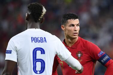 France's midfielder Paul Pogba interacts with Portugal's forward Cristiano Ronaldo during the UEFA EURO 2020 Group F football match between Portugal and France at Puskas Arena in Budapest on June 23, 2021. / AFP / POOL / FRANCK FIFE