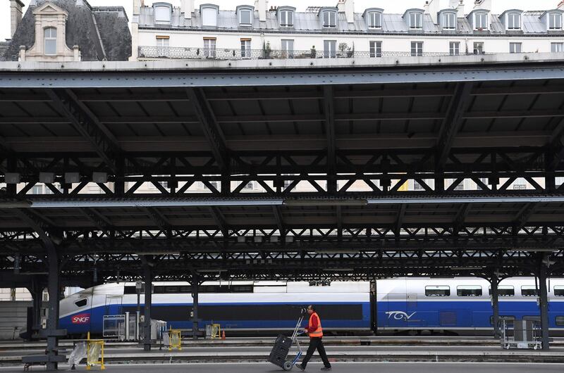 An employee pushes a trolley on an empty platform near a TGV high speed train at the Gare de l'Est station in Paris, on the second day of  rail strikes. Christophe Archambault / AFP