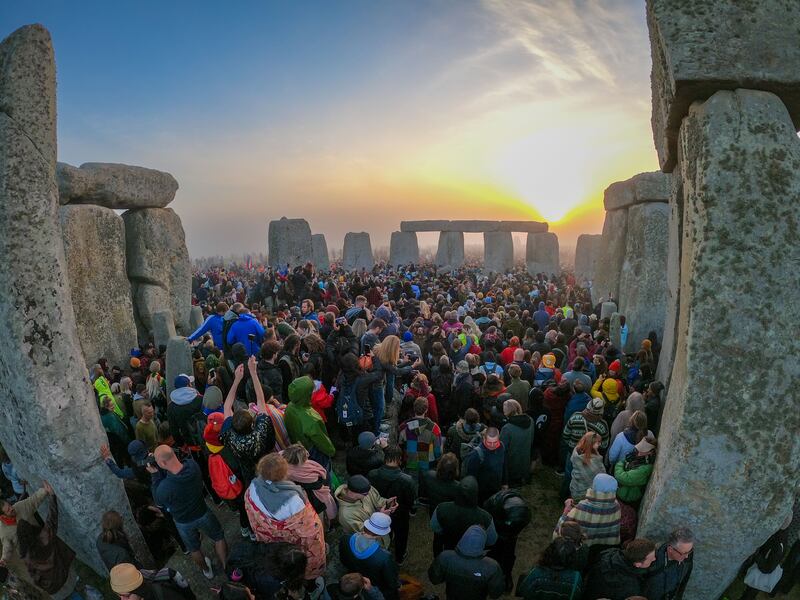 People gather for sunrise at Stonehenge, in Wiltshire, southern England. The summer solstice on June 21 is the longest day and shortest night of the year in the Northern Hemisphere. Getty
