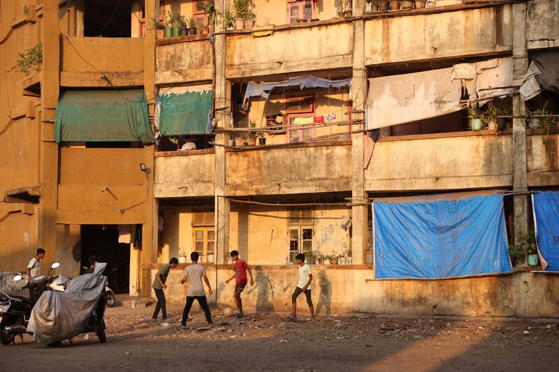 Children play football outside the Worli dairy quarters building in Mumbai, India. All photos: Reuters 