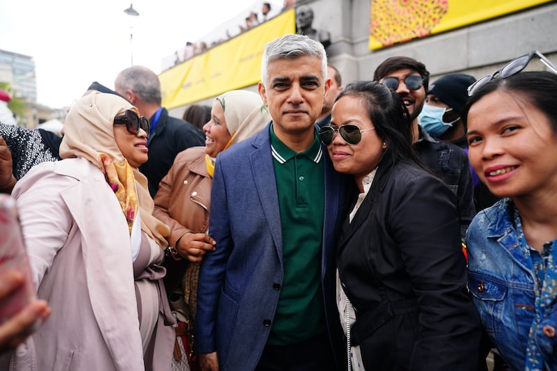 People take pictures with Mayor of London Sadiq Khan during the Eid in the Square festival in Trafalgar Square. PA