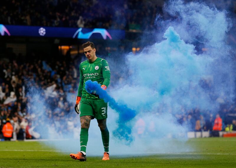 Manchester City's Ederson throws a flare off the pitch after Phil Foden scored their third goal. Action Images