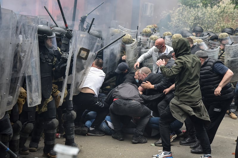 Nato-led Kosovo Force soldiers clash with local Serb protesters at the entrance to the municipality building in the town of Zvecan on May 29. Reuters