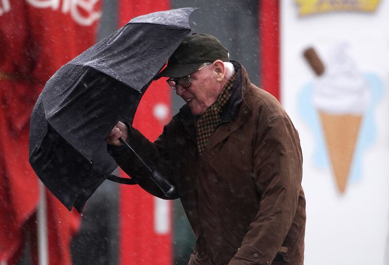 A man struggles against strong wind in Clontarf, Dublin, as Storm Dudley makes its way over Ireland. PA