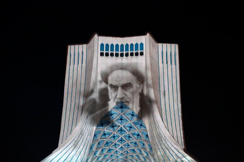 Tehran's Azadi tower is illuminated with pictures of Iranian supreme leader Ayatollah Ruhollah Khomeini on the 33rd anniversary of his death in June 2022. EPA