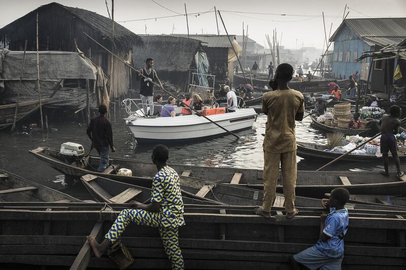 Jesco Denzel's image shows a boat with tourists from Lagos Marina, steered through the canals of the Makoko community - an ancient fishing village that has grown into an enormous informal settlement, on the shores of Lagos Lagoon, Lagos, Nigeria. He took first place in the 'Contemporary Issues - Singles' category. EPA/JESCO DENZEL