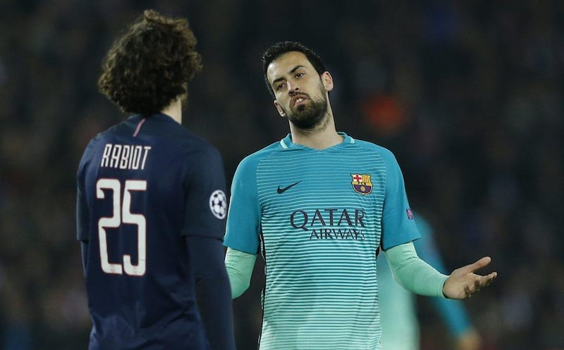Barcelona's Sergio Busquets gestures towards Paris Saint-Germain's Adrien Rabiot. Benoit Tessier / Reuters