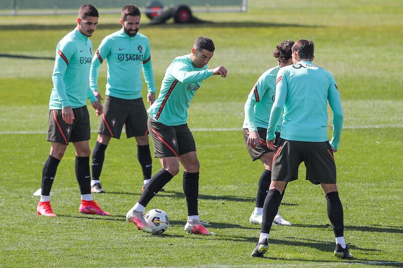 Cristiano Ronaldo, centre, during a training session in Turin, Italy, ahead of their upcoming 2022 World Cup qualifier against Azerbaijan on 24 March. EPA