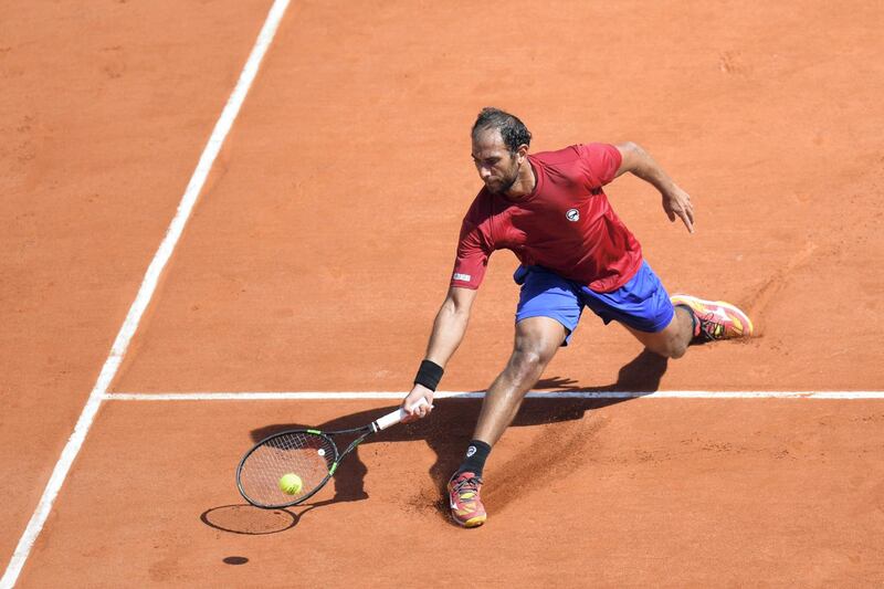 Egypt's Mohamed Safwat plays a return to Bulgaria's Grigor Dimitrov during their men's singles first round match on day one of The Roland Garros 2018 French Open tennis tournament in Paris on May 27, 2018. (Photo by CHRISTOPHE ARCHAMBAULT / AFP)        (Photo credit should read CHRISTOPHE ARCHAMBAULT/AFP/Getty Images)