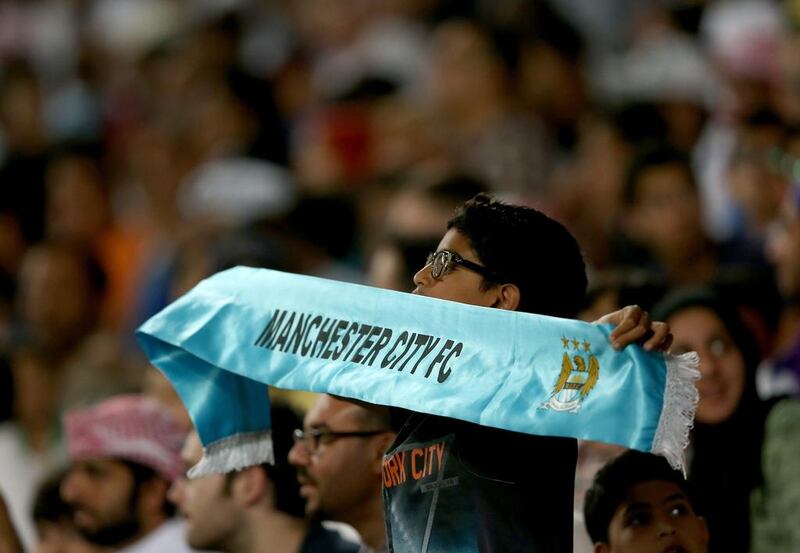 A young fan cheers on Manchester City during their match against Al Ain on Thursday. Warren Little / Getty Images / May 15, 2014