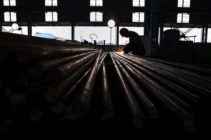 A worker welds steel bars for export in the production area of the Zhong Tian (Zenith) Steel Group Corporation. Beijing has set up a fund to restructure companies. Kevin Frayer / Getty 