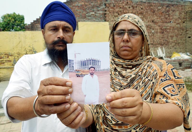 AMRITSAR, INDIA  JUNE 18: Sialka village residents Ranjit Kaur(R) and Balkar Singh (L) hold a picture of their son Jatinder Singh  who is reportedly abducted in the troubled city of Mosul in Iraq, on June 18, 2014 in Amritsar, India. Forty Indian construction workers have been kidnapped from the militant-controlled city of Mosul in northern Iraq. Most of the boys from Amritsar and surrounding villages are between the ages of 25 to 35 and lived in Mosul. Most of them worked with a construction company there. The government has received information about the location of 40 Indian construction workers abducted in strife-torn northern Iraq, external affairs ministry spokesperson Syed Akbaruddin said on Friday. External affairs minister Sushma Swaraj earlier said the government would leave no stone unturned to free the Indian workers being held in the Iraqi city of Mosul. (Photo by Sameer Sehgal/Hindustan Times via Getty Images)