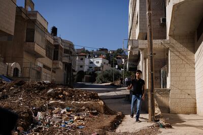 A boy walks around a road block placed by settlers in Huwara in the West Bank. Getty 