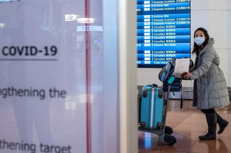 A passenger pushes a baggage trolley in the arrivals hall at Tokyo's Haneda airport on December 27, 2020, after the government announced more restrictions on travel due to the rise of COVID-19 coronavirus infections across the country. / AFP / Philip FONG
