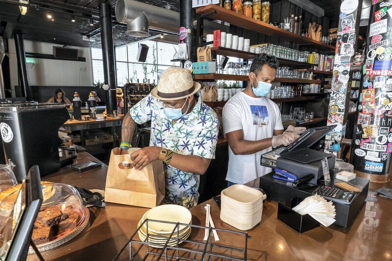 DUBAI, UNITED ARAB EMIRATES. 08 JUNE 2020. Staff at Nightjar Coffee in Al Serkal Avenue, Al Quoz follow strict sanitary procedures due to the current COVID-19 Pandemic to ensure health and safety measures put in place by Dubai Municipality is adhered to. All staf adhere to a strict policy of hygeine while preparing food in this busy F&B outlet. (Photo: Antonie Robertson/The National) Journalist: None. Section: National.