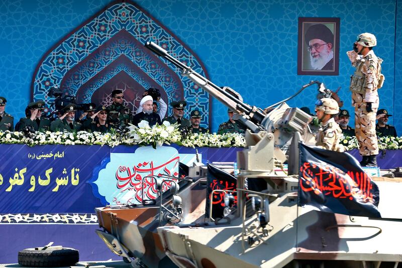 FILE - In this Sept. 22, 2017 file photo, Iran's President Hassan Rouhani, center, reviews a military parade during the 37th anniversary of Iraq's 1980 invasion of Iran, in front of the shrine of the late revolutionary founder, Ayatollah Khomeini, just outside Tehran, Iran. Facing a second suspected Israeli strike killing Iranian forces in Syria, the Islamic Republic has few ways to retaliate as its officials wrestle both domestic unrest at home and the prospects of its nuclear deal collapsing abroad. (AP Photo/Ebrahim Noroozi, File)