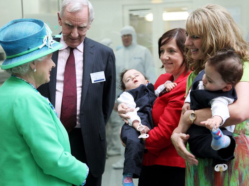 The queen with Angie Benhaffaf and her twins, Hassan and Hussein, during a visit to Ireland in 2011. Getty