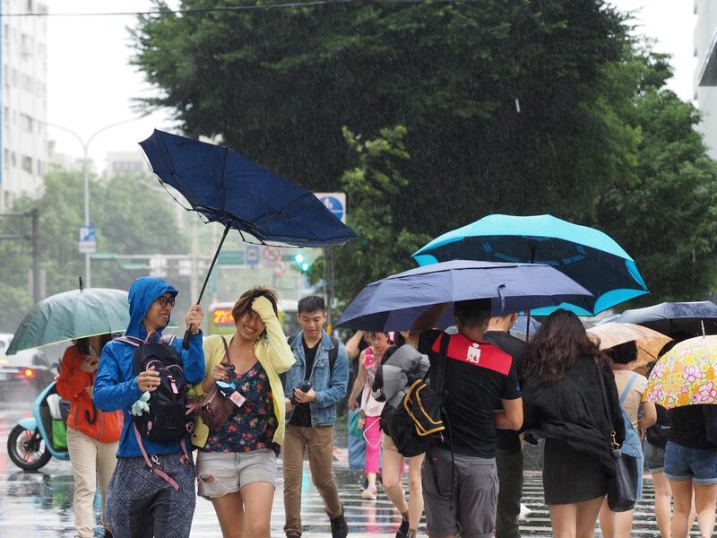 People cross the street under the rain in Taipei, Taiwan. According to The Central Weather Bureau, Typhoon Mitag is expected to bring strong wind and heavy rain to Taiwan between 30 September and 01 October, as it skirts Taiwan's east coast.  EPA