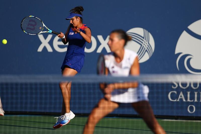 Sania Mirza of India hits a forehand past Flavia Pennetta of Italy during their doubles match against Katarina Srebotnik of Slovakia and Jelena Jankovic of Serbia at the Southern California Open in August.   Joe Scarnici / AFP