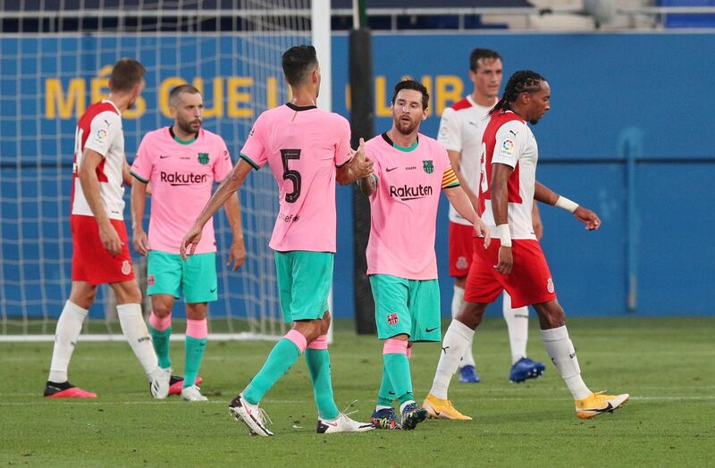 Barcelona's Lionel Messi celebrates scoring their second goal with Sergio Busquets. Reuters